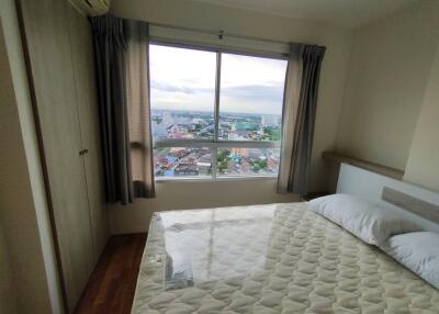 Cozy bedroom with city view through large window