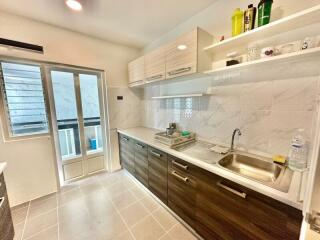 Modern kitchen with wooden cabinets and white countertops