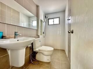 Modern bathroom with tiled walls and natural light