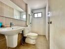 Modern bathroom with tiled walls and natural light