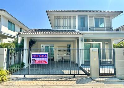 Modern two-story house for sale with a spacious front yard and balcony