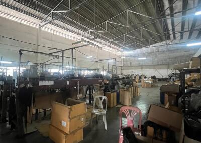 Spacious warehouse interior with storage boxes and equipment
