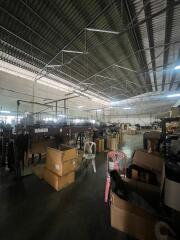 Spacious warehouse interior with storage boxes and equipment