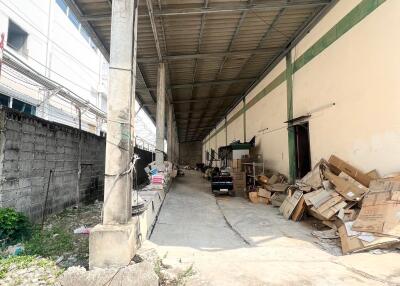 Spacious industrial warehouse interior with concrete flooring and storage area