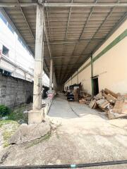 Spacious industrial warehouse interior with concrete flooring and storage area