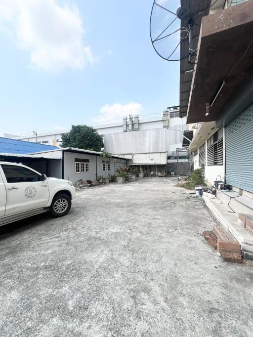 Spacious outdoor parking area with surrounding industrial buildings