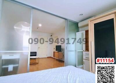 Spacious bedroom with mirrored wardrobe and view into living area