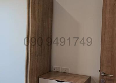 Compact bedroom with wood furniture and air conditioning unit