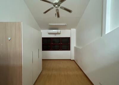 Spacious bedroom with ceiling fan and built-in storage