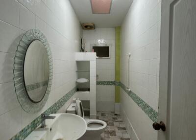 Compact modern bathroom with tiled flooring