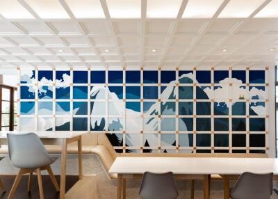 Modern dining room with artistic mountain wall mural and stylish furnishings