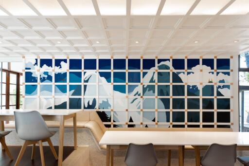 Modern dining room with artistic mountain wall mural and stylish furnishings