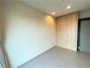 Empty bedroom with wooden wardrobe and modern lighting