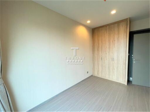 Empty bedroom with wooden wardrobe and modern lighting