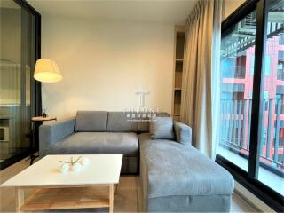 Modern living room with ample natural light and comfortable seating