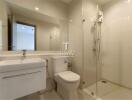 Modern bathroom interior with glass shower and ceramic fixtures