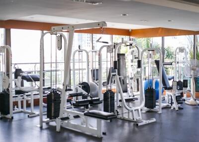 Modern gym with various exercise machines in a residential building