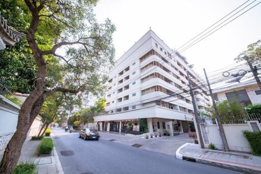 Exterior view of a modern multi-story residential building on a sunny day