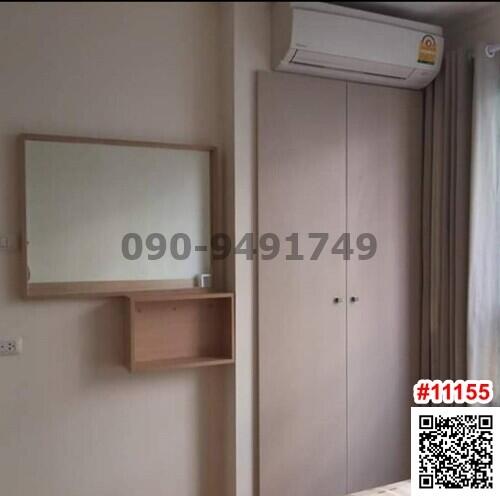 Compact bedroom with air conditioning unit and built-in wardrobe