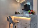 Modern kitchen with marble countertop and pendant lights