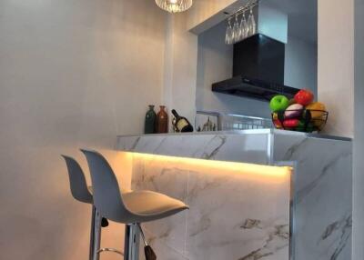 Modern kitchen with marble countertop and pendant lights
