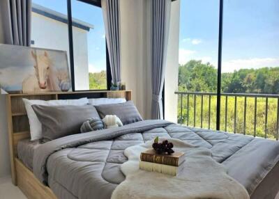 Modern bedroom with large windows and a scenic view