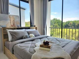 Modern bedroom with large windows and a scenic view