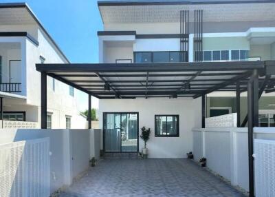 Spacious modern residential home exterior with carport