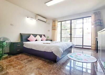 Spacious bedroom with modern furnishings and ample natural light