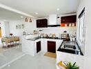 Modern kitchen with white countertops, wooden cabinets, and stainless steel appliances