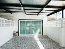 Bright modern patio with transparent roofing and patterned tile flooring