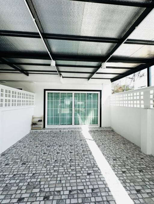 Bright modern patio with transparent roofing and patterned tile flooring