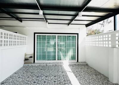 Bright modern patio with transparent roofing and patterned tile flooring
