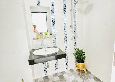 Modern bathroom with walk-in shower and white tiling