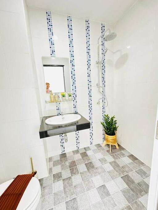 Modern bathroom with walk-in shower and white tiling