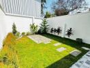 Modern backyard with landscaped garden and tiled path