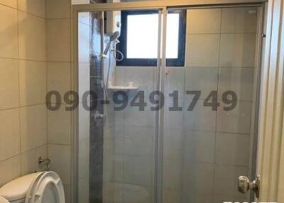 Compact modern bathroom with glass shower and white toilet