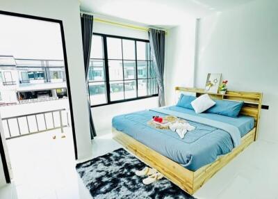 Bright and cozy bedroom with large windows and balcony access