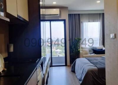 Compact studio apartment with combined kitchen and bedroom space with city view