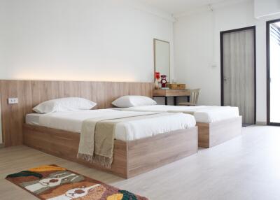Bright and spacious bedroom with twin beds and wooden furnishings