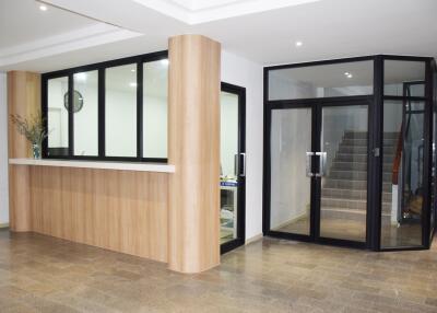 Modern building lobby with reception desk and glass door entrance