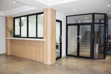 Modern building lobby with reception desk and glass door entrance