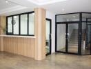 Modern building lobby with reception desk and glass door entrance