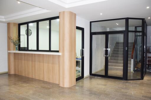 Modern building lobby with reception desk and glass door entrance