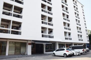 Modern multi-story residential building with parking