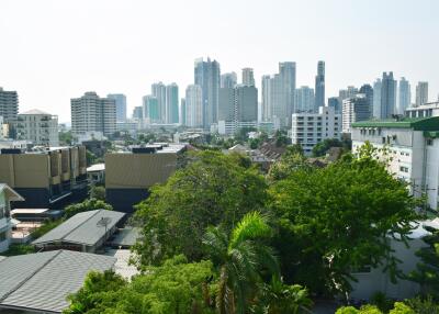 View of a vibrant cityscape with modern high-rise buildings and lush greenery