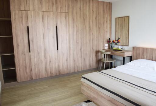 Modern bedroom with wooden furniture and neutral tones