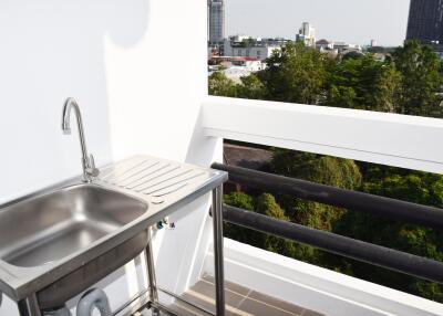 Balcony with stainless steel sink and city view