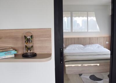 Modern bedroom with a city view through the large window
