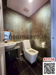 Modern bathroom interior with black tiled walls and flooring